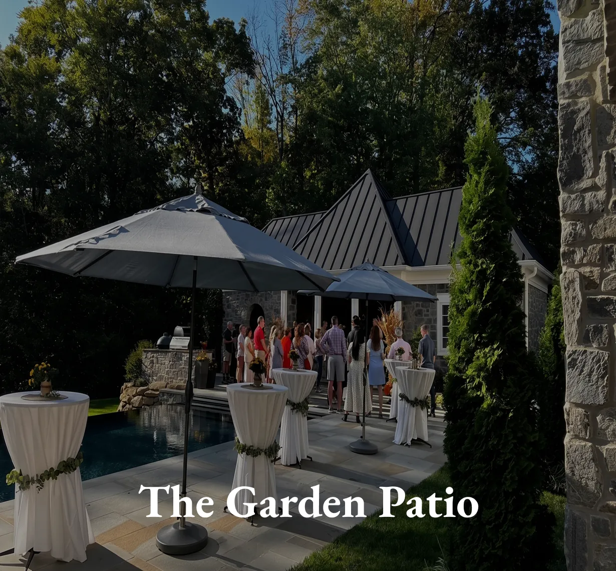 The Garden Patio, an outdoor terrace with umbrellas and cocktail tables