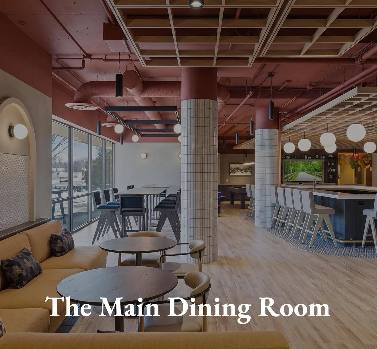 The Main Dining Room, with booth seating and round tables under a timber ceiling