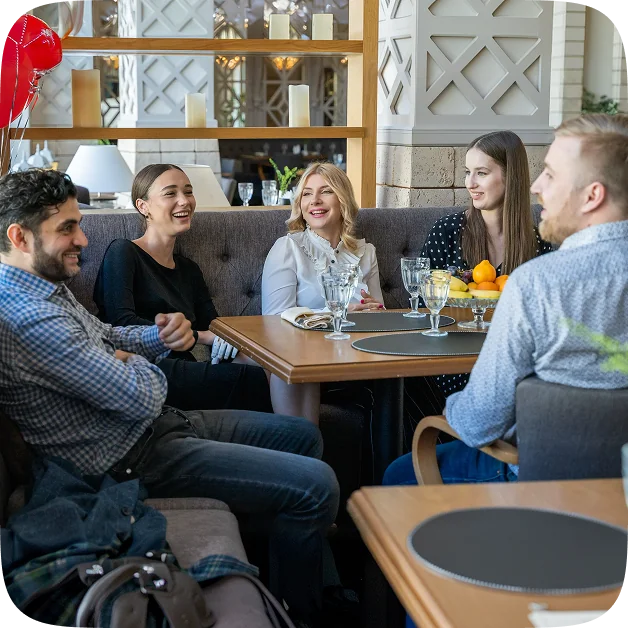 Colleagues sharing a meal in a restaurant booth