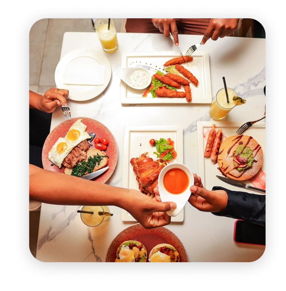 Friends sharing a spread of dishes at a table