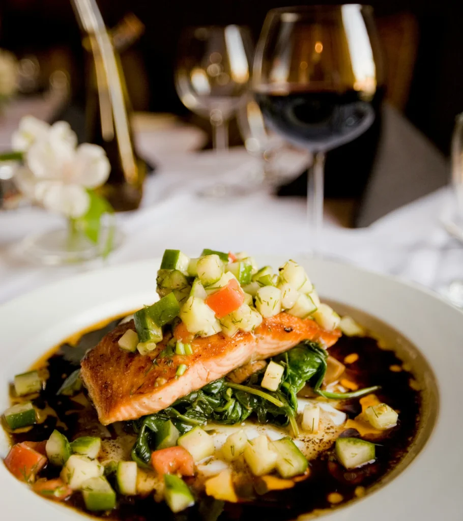 Salmon with diced vegetables served at a candlelit dinner