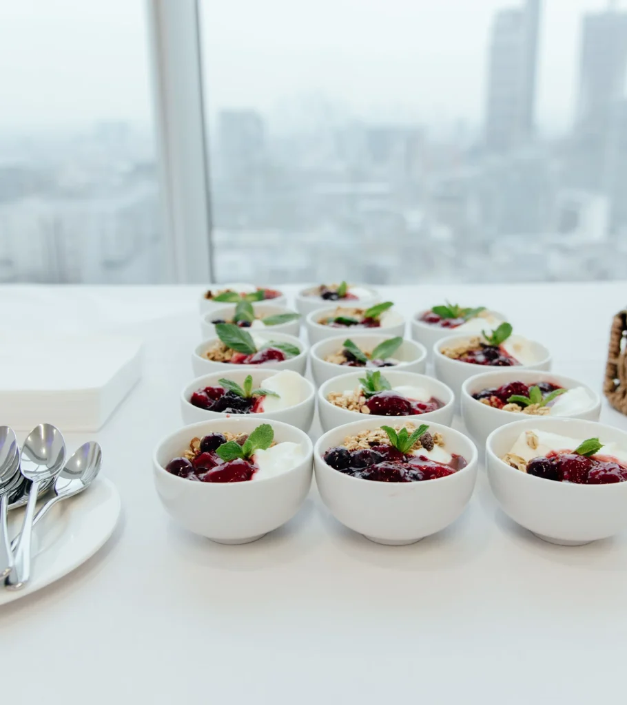 Rows of individual desserts set out for a corporate lunch