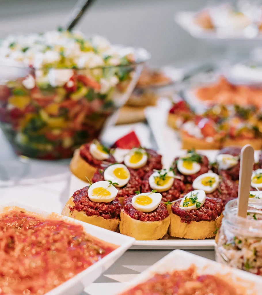Canapes topped with quail eggs on a buffet